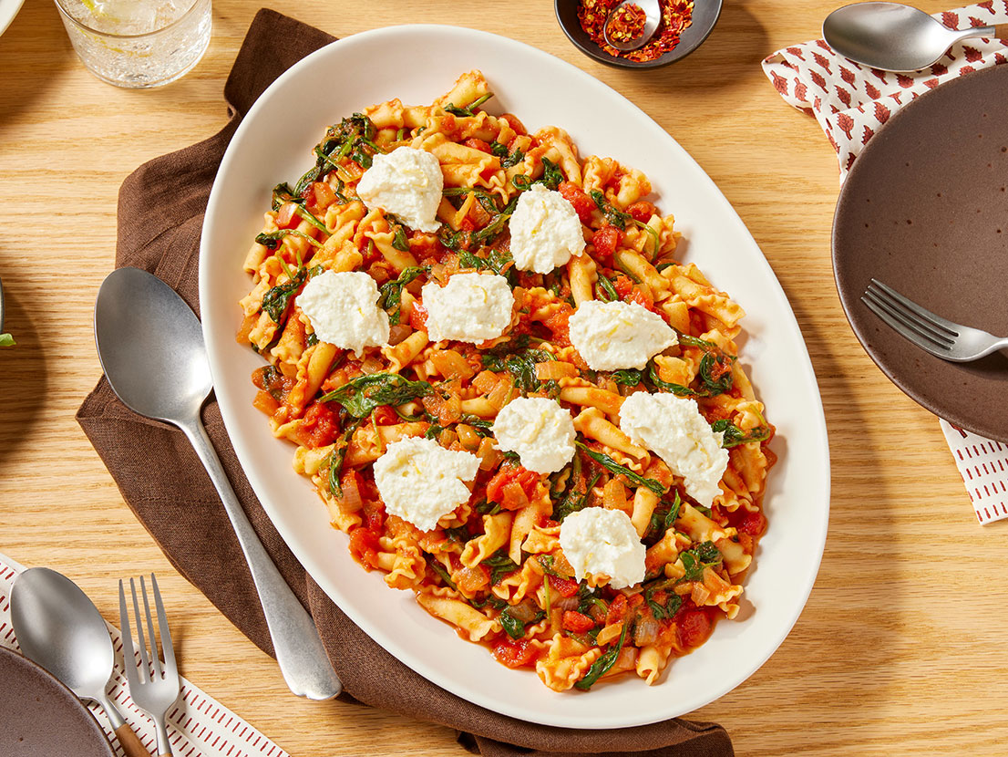 An image of prepared Tomato & Spinach Pasta with Lemon Ricotta made with Prego® Margherita Sauce, pasta, spinach, ricotta and lemon.