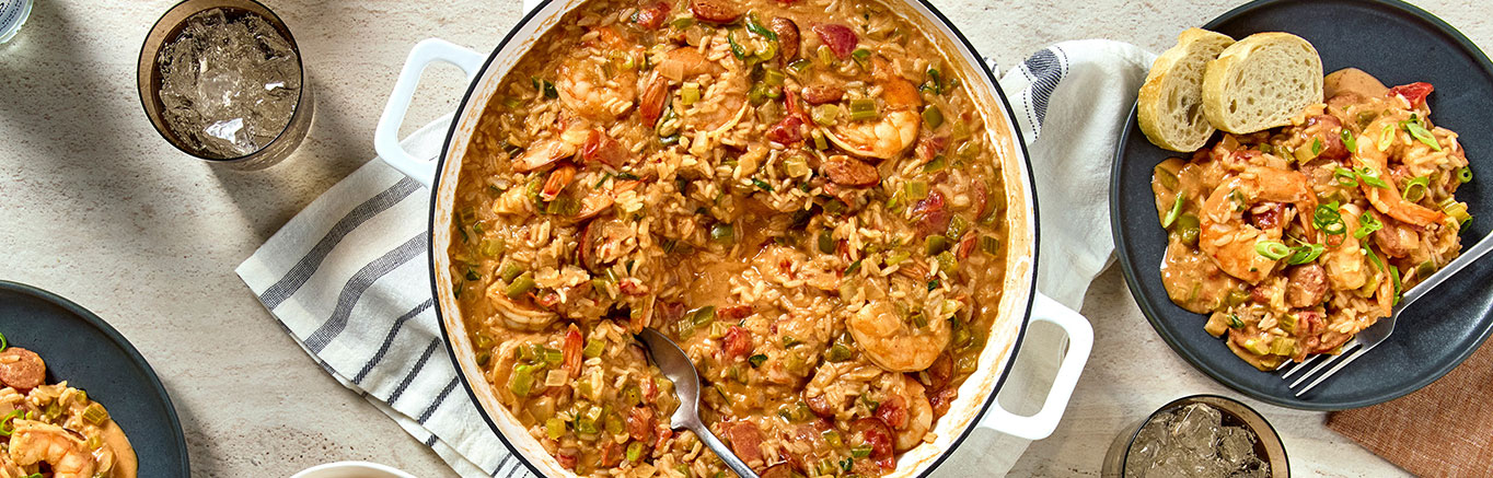 An image of prepared Creamy Cajun Jambalaya made with Swanson® Natural Goodness® Chicken Broth, rice, andouille sausage, celery, onion, green bell pepper, garlic, Prego® Cajun Alfredo Pasta Sauce, diced tomatoes, shrimp and green onions.