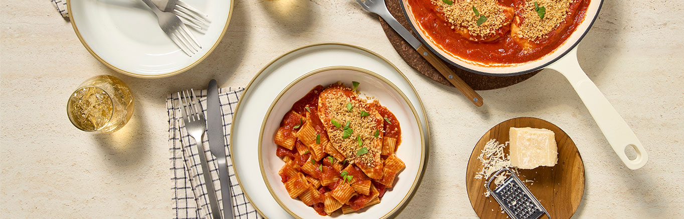 An image of prepared Easy Margherita Chicken made with panko, Parmesan cheese, chicken, Prego® Margherita Sauce and fresh basil.