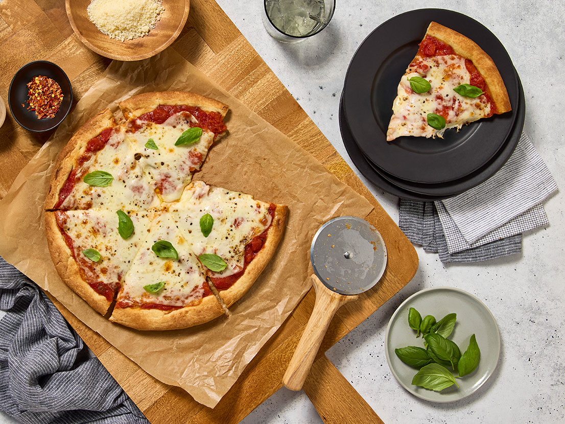 An image of prepared Margherita Pizza made with Prego® Margherita Sauce, mozzarella cheese and basil.