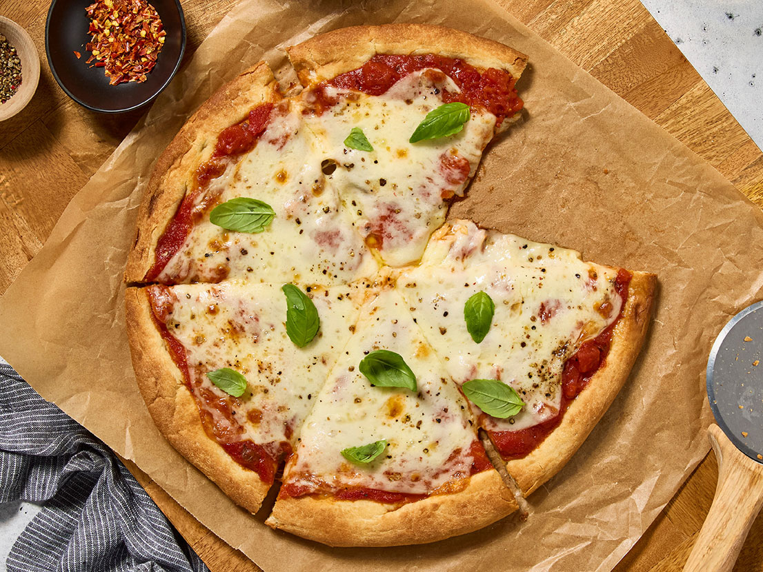 An image of prepared Margherita Pizza made with Prego® Margherita Sauce, mozzarella cheese and basil.