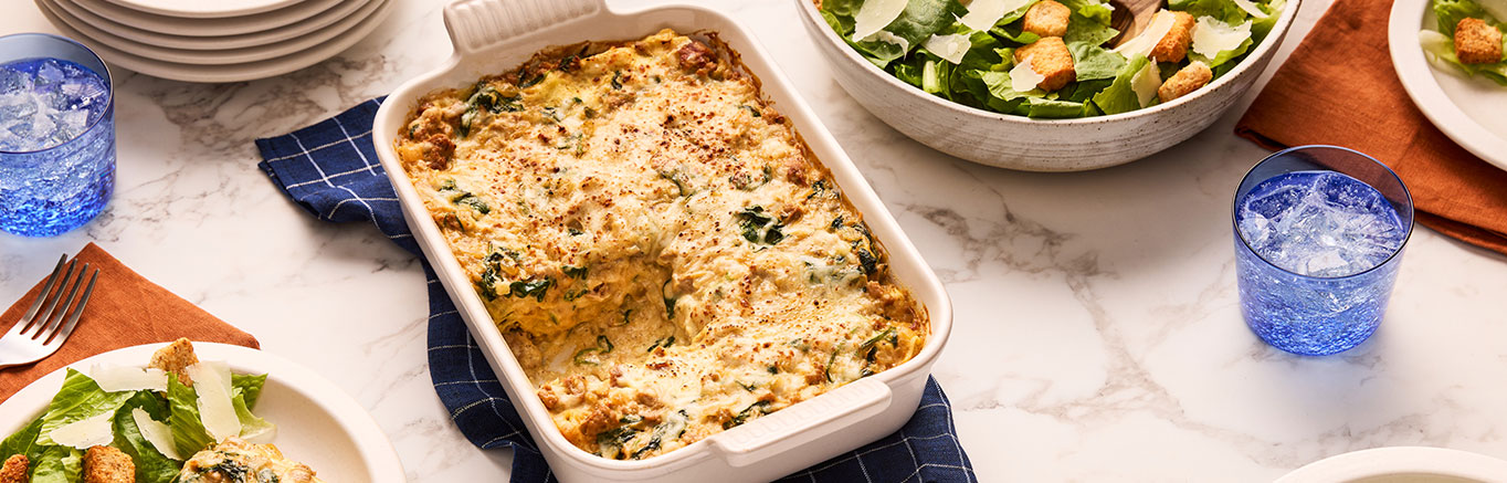 An image of prepared Creamy Butternut Squash Alfredo Lasagna made with Prego® Creamy Butternut Squash Alfredo Sauce, Italian-style turkey sausage, baby spinach, ricotta, Parmesan and ground sage.