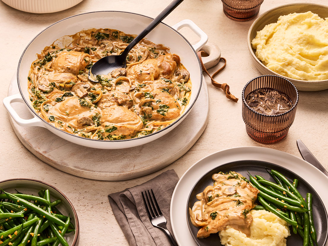 An image of prepared Creamy Butternut Squash Chicken & Mushroom Skillet made with Prego® Creamy Butternut Squash Alfredo Sauce, Swanson® 33% Less Sodium Chicken Broth, kale, chicken and mushrooms.