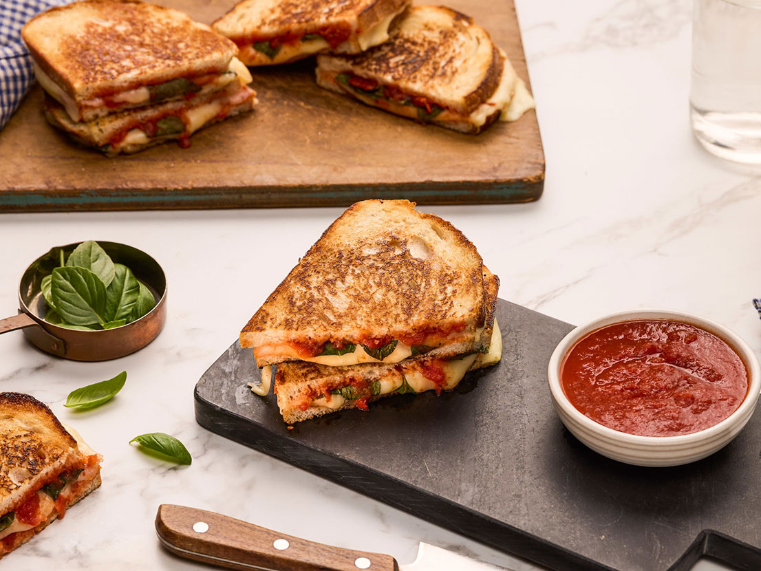 An image of prepared Margherita Pizza Grilled Cheese made with sourdough bread, Prego® Margherita Sauces, basil and mozzarella cheese.