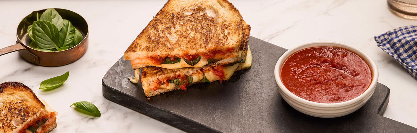 An image of prepared Margherita Pizza Grilled Cheese made with sourdough bread, Prego® Margherita Sauces, basil and mozzarella cheese.