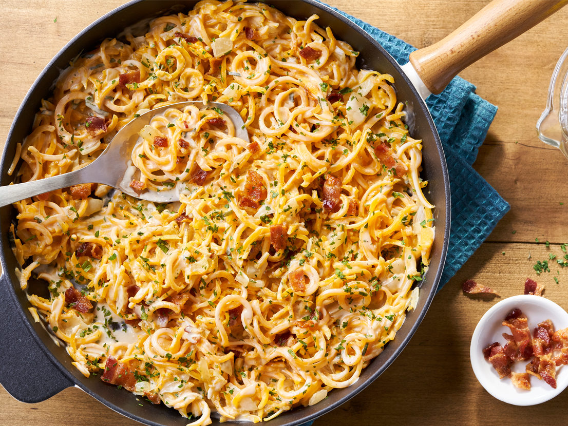An image of prepared Butternut Squash Carbonara made with butternut squash noodles, onion, Prego® Roasted Garlic Parmesan Alfredo Sauce, Swanson® Vegetable Broth, sage, lemon, bacon and parsley.