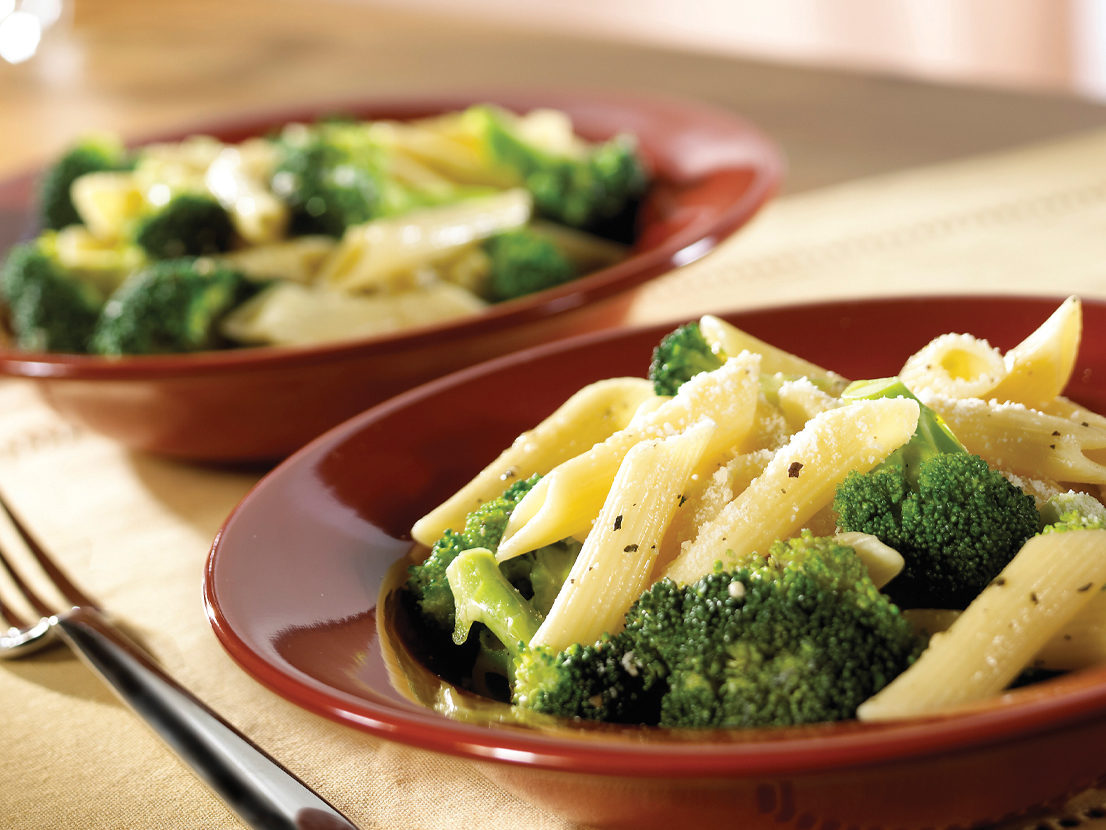 An image of prepared Broccoli & Garlic Penne Pasta made with Swanson® Chicken Broth, broccoli, penne pasta and Parmesan cheese.