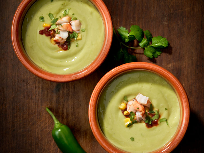 An image of prepared Chilled Chipotle Avocado Soup made with avocado, garlic, Swanson® Chicken Bone Broth, peppers, cilantro, corn and shrimp.