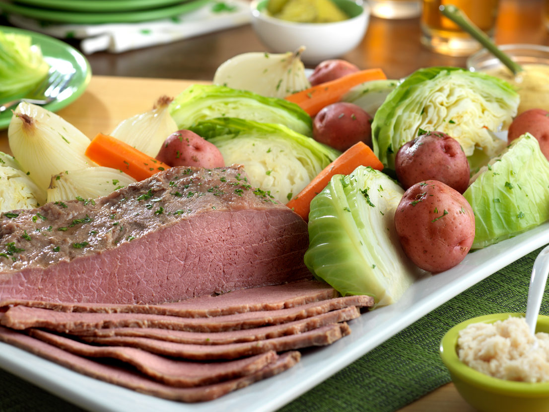 An image of prepared Corned Beef and Cabbage made with beef brisket, beer, Swanson® 50% Less Sodium Beef Broth, onion, potato, carrot and green cabbage.