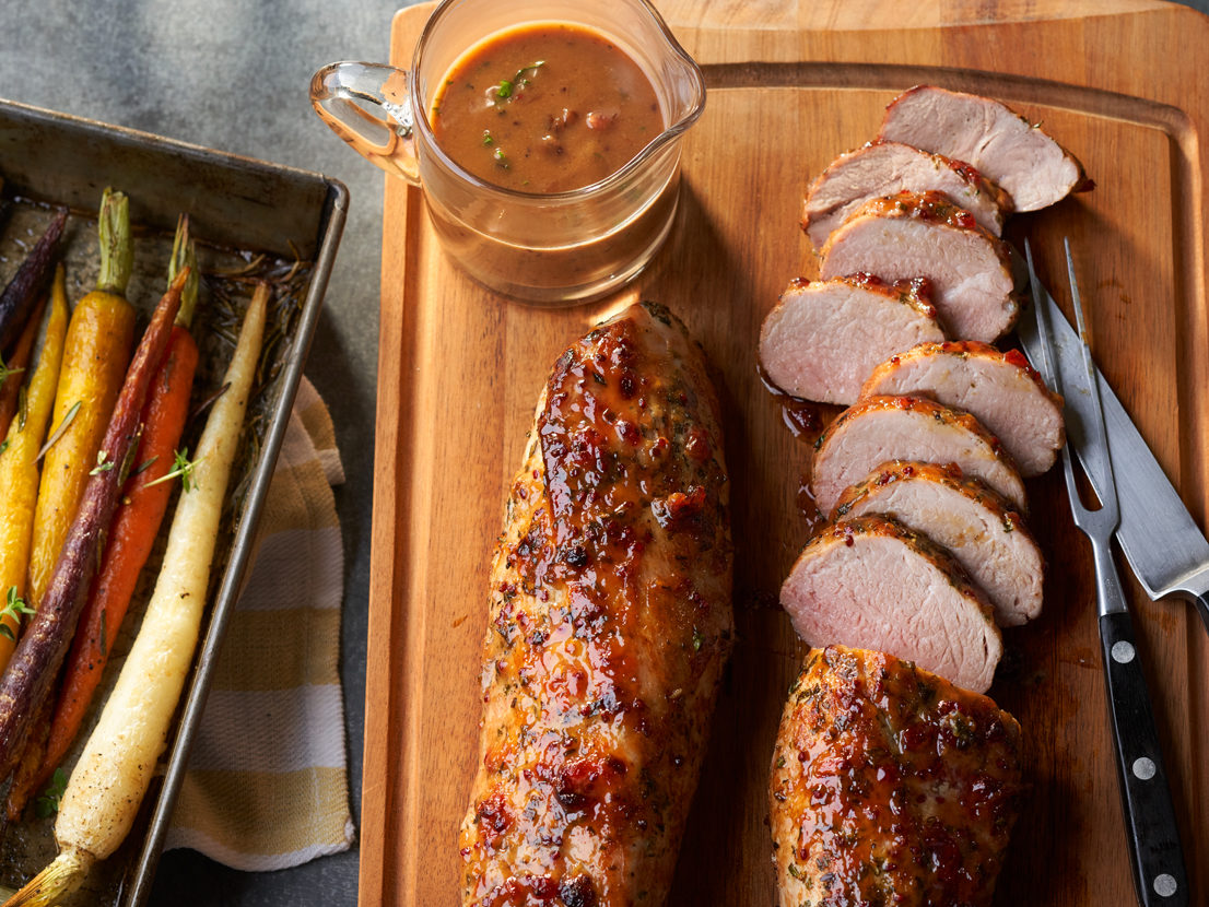 An image of prepared Dijon-Herb Pork Roast made with pork tenderloin, parsley, rosemary, thyme, red currant jelly, Dijon and Swanson® Chicken Stock.