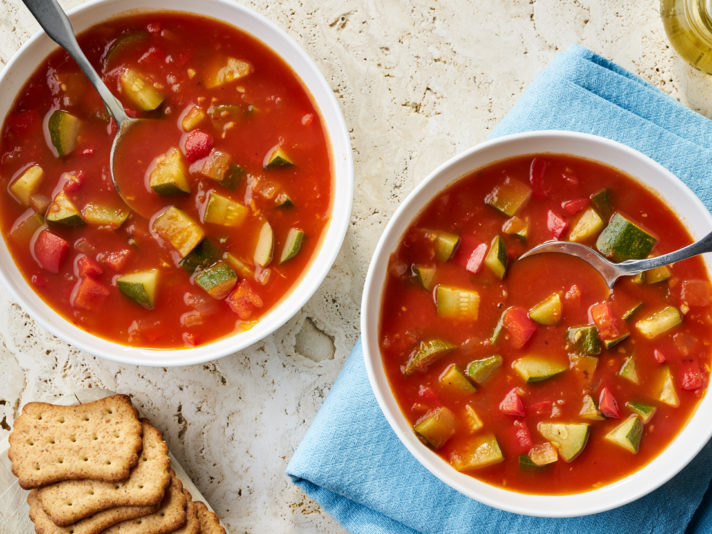 An image of prepared Garden Vegetable Soup made with onion, zucchini, red bell pepper, Swanson® Natural Goodness® Chicken Broth or Vegetable Broth, crushed tomatoes and basil.