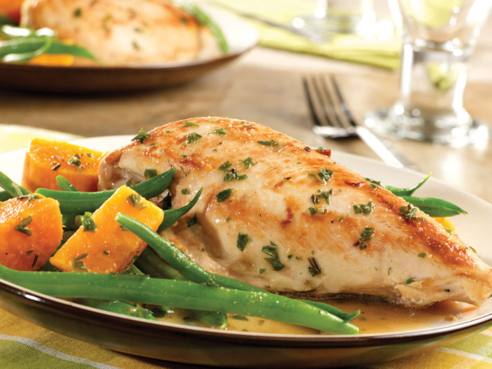 An image of prepared Golden Chicken & Autumn Vegetables made with chicken, Swanson® Natural Goodness® Chicken Broth, garlic, rosemary, thyme, sweet potato and green beans.