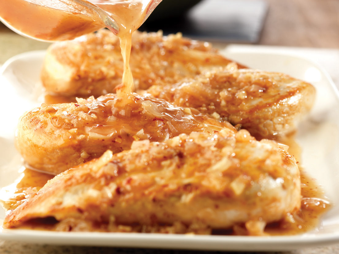 An image of prepared Maple Dijon Chicken made with chicken, shallots, garlic, Swanson® Chicken Broth, Dijon-style mustard and maple-flavored syrup.