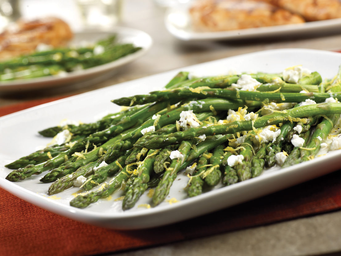An image of prepared Roasted Asparagus with Lemon & Goat Cheese made with asparagus, Swanson® Vegetable Broth, goat cheese and lemon.