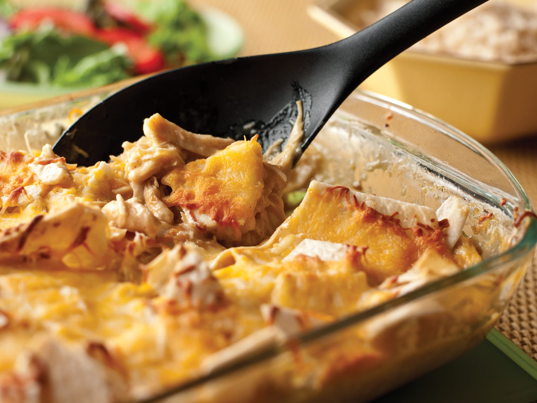 An image of prepared Slow Cooker Cheesy Chicken & Tortillas made with chicken, Swanson® Natural Goodness® Chicken Broth, Campbell's® Condensed Cream of Chicken Soup, flour tortillas, Mexican blend cheese and white rice.