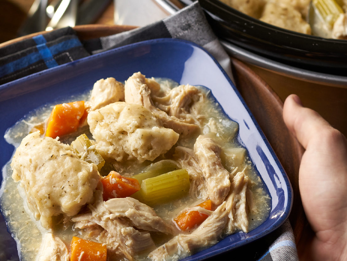 An image of prepared Slow Cooker Chicken & Herb Dumplings made with chicken, carrots, celery, onion, Swanson® Chicken Broth and dumplings.