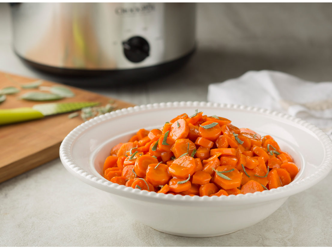 An image of prepared Slow Cooker Orange-Glazed Carrots made with carrots, Swanson® Chicken Broth, brown sugar, orange marmalade, butter and sage.