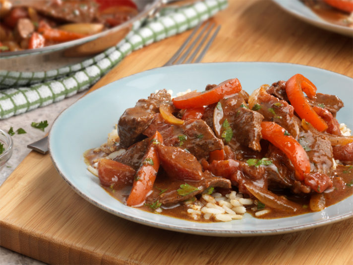 An image of Spanish Beef made with Swanson® Beef Stock, chili powder, cumin, beef sirloin steak, onion, red bell pepper, canned diced tomatoes and cilantro.
