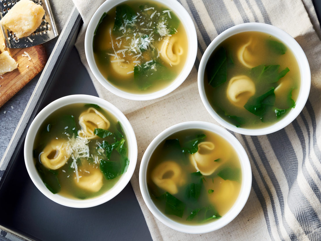 An image of prepared Spinach Tortellini Soup made with Swanson® Natural Goodness Chicken Broth, garlic powder, cheese tortellini and fresh spinach.