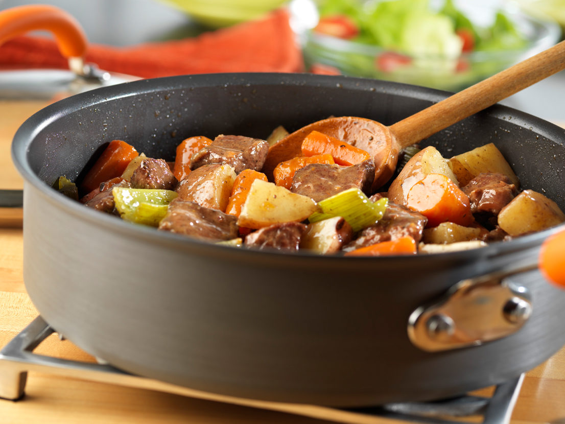 An image of prepared Vegetable Beef Stew made with beef, Swanson® Vegetable Broth, carrots, potatoes and celery.