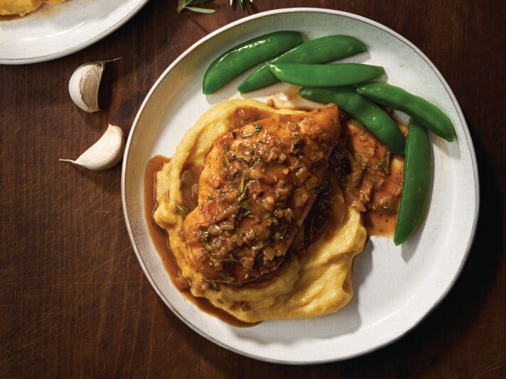 An image of prepared Balsamic Rosemary Chicken made with chicken, Swanson® Chicken Bone Broth, rosemary, cornmeal and Parmesan cheese.