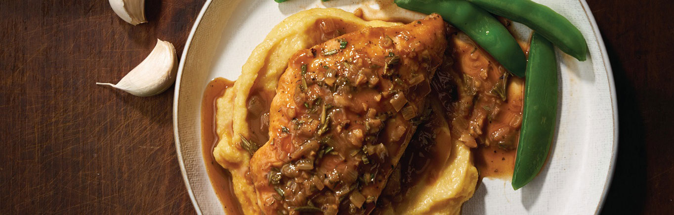 An image of prepared Balsamic Rosemary Chicken made with chicken, Swanson® Chicken Bone Broth, rosemary, cornmeal and Parmesan cheese.