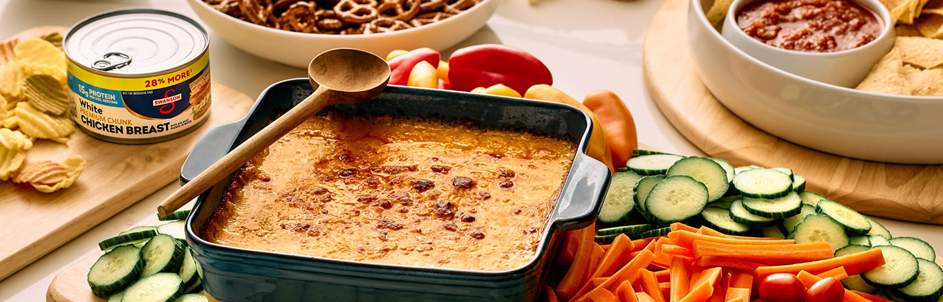 An image of prepared Buffalo Chicken Dip made with Campbell's® Condensed Spicy Buffalo-Style Cream of Chicken Soup, Swanson® Premium White Chunk Chicken Breast and Monterey Jack cheese.