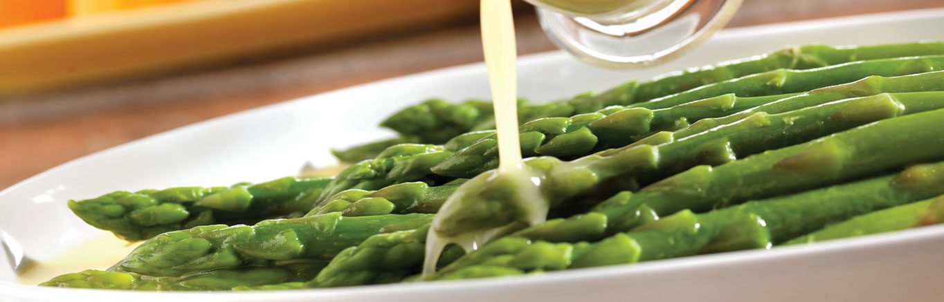 An image of prepared Butter-Glazed Asparagus made with Swanson® Chicken Broth, asparagus and butter.