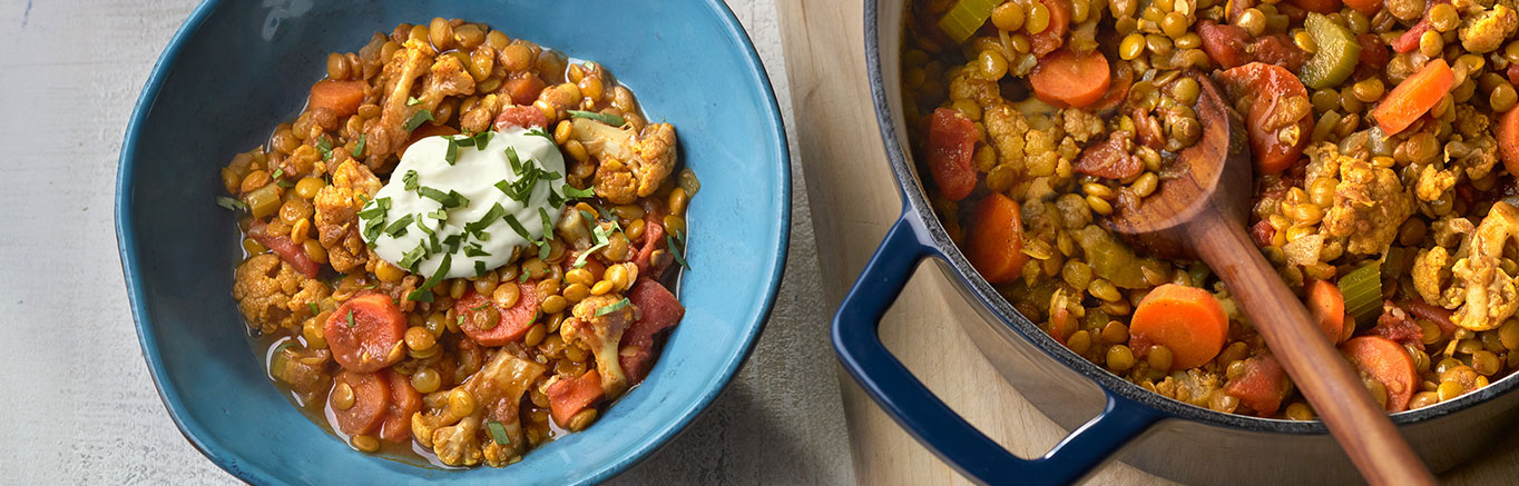 An image of prepared Cauliflower & Lentil Stew made with onion, carrot, celery, cauliflower, lentils, cumin, coriander, turmeric, cinnamon, tomatoes and Swanson® Vegetable Broth.