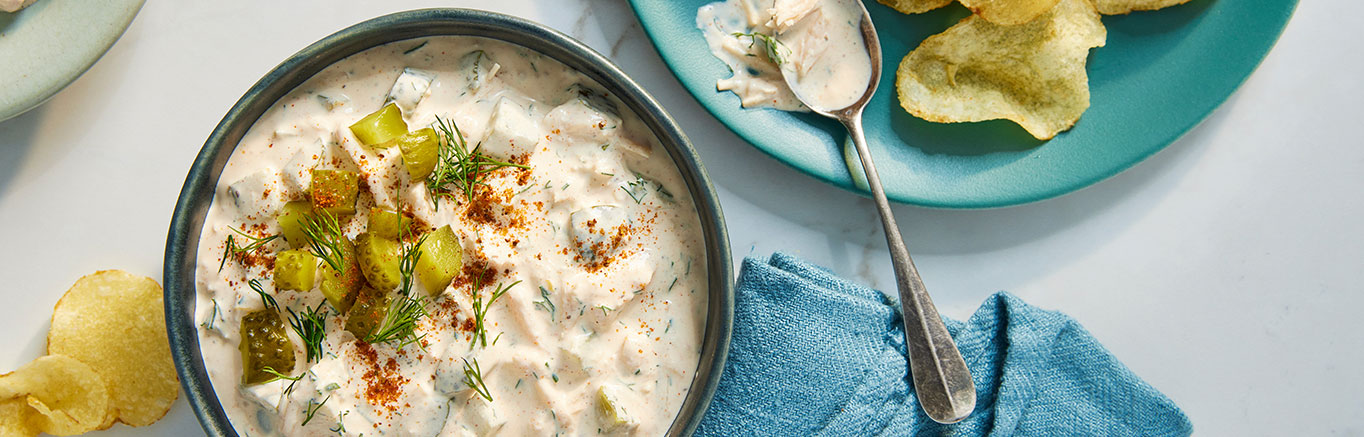 An image of prepared Chicken and Dill Pickle Dip made with Swanson® Premium White Chicken, cream cheese, sour cream and dill pickles.