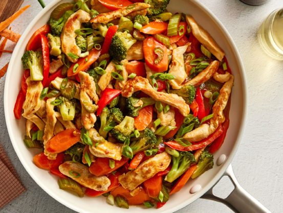 An image of prepared Chicken & Vegetable Stir-Fry made with Swanson® Chicken Broth, chicken, vegetables and white rice.