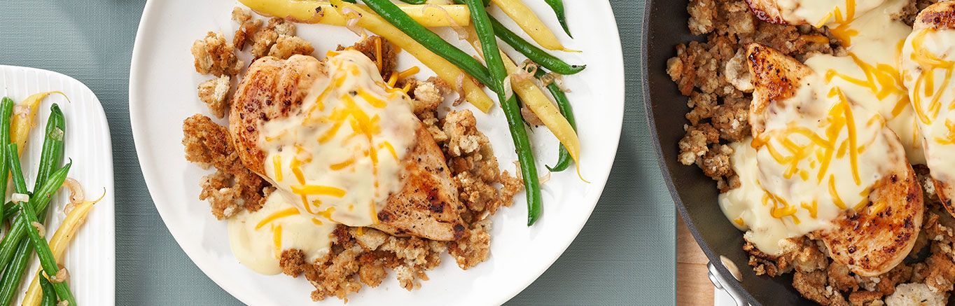 An image of prepared Chicken & Stuffing Skillet showing chicken breast, Swanson® Chicken Broth, Pepperidge Farm® Herb Seasoned Stuffing, Campbell's® Condensed Cream of Chicken Soup and Cheddar cheese.