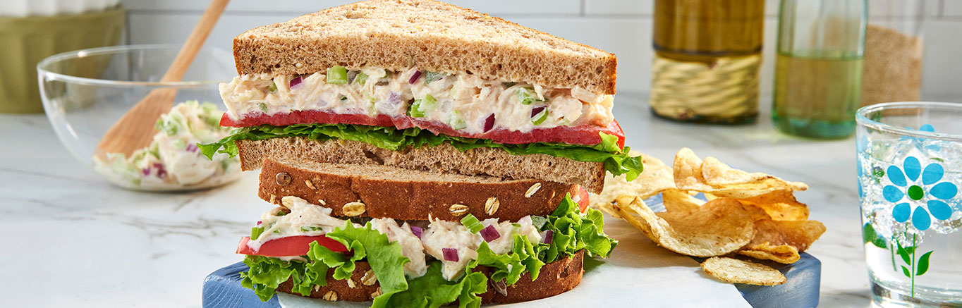 An image of prepared Classic Chicken Salad made with Swanson® Premium White Chicken, mayonnaise, celery, onion, carrot and Pepperidge Farm® Whole Grain 15 Grain Bread.
