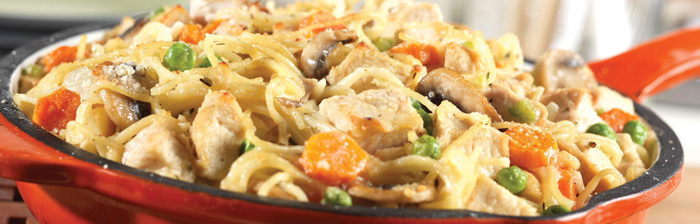An image of prepared Classic Chicken Tetrazzini made with mushrooms, Swanson® Chicken Broth, chicken or turkey, peas, spaghetti and Parmesan cheese.