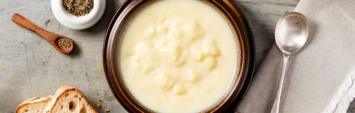 An image of prepared Creamy Potato Soup made with potatoes and Swanson® Chicken Broth.
