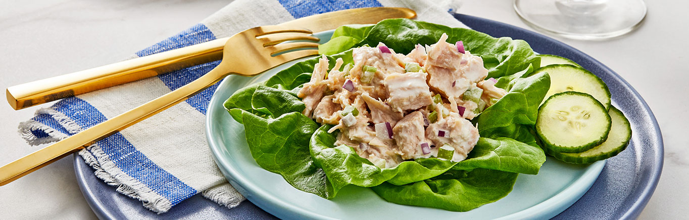 An image of prepared Easy Chicken Salad made with mayonnaise, Swanson® Premium White Chunk Chicken and mixed salad greens.