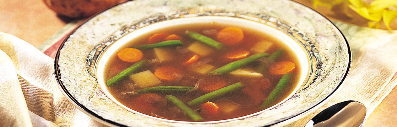 An image of prepared Easy Vegetable Soup made with onion, garlic, Swanson® Vegetable Broth, carrot, potato and green beans.