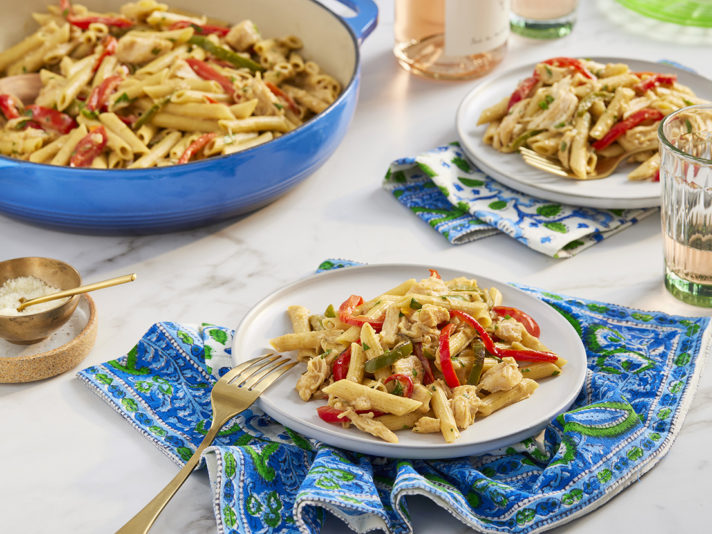 An image of prepared Cajun Chicken Alfredo made with bell pepper, garlic, Swanson® Natural Goodness® Chicken Broth, penne pasta, Swanson® Premium White Chicken, cream and Parmesan cheese.