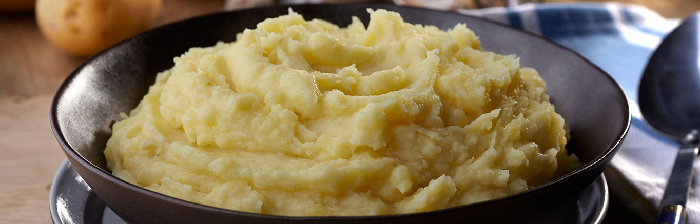 An image of prepared Garlic Mashed Potatoes made with Swanson® Chicken Broth, garlic and potatoes.