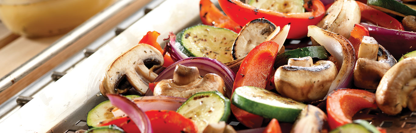 An image of prepared Herb Grilled Vegetables made with Swanson® Chicken Broth, red onion, bell pepper, zucchini, yellow squash and mushrooms.