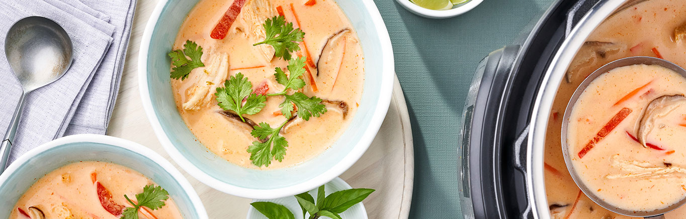 Image of prepared Instant Pot​® Thai Chicken Soup made with carrots, shiitake mushrooms, chicken, curry paste, Swanson Chicken Broth®, coconut milk and cilantro.