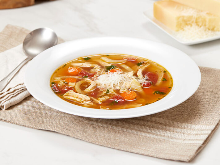 An image of prepared Italian-Style Chicken Noodle Soup made with fennel, diced tomatoes, Swanson® Chicken Broth, chicken, ditalini and Parmesan.