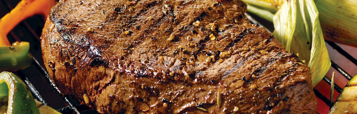 An image of prepared Jerk-Spiced Beef Sirloin made with beef sirloin steak, Swanson® Beef Stock or Beef Broth, Jamaican Jerk seasoning and garlic.
