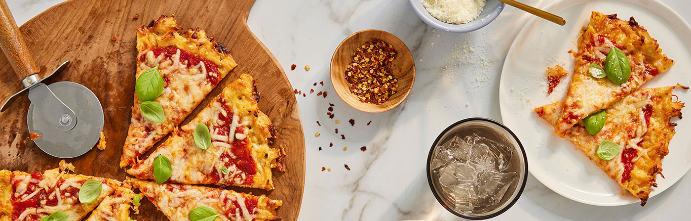 An image of prepared Keto-Friendly Chicken Crust Pizza made with Swanson® Premium White Chicken Breast, mozzarella cheese, Parmesan cheese and Prego® Traditional No Sugar Added Italian Sauce.