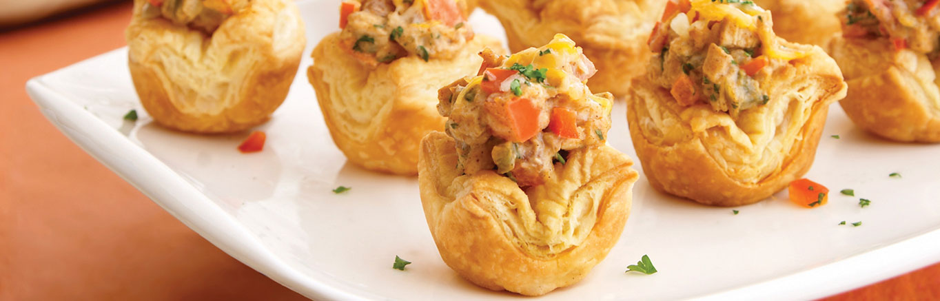 An image of prepared King Ranch Chicken Shells made with chicken, anaheim pepper, bell pepper, Swanson® Chicken Broth or Chicken Stock, cilantro, Pepperidge Farm® Puff Pastry and Cheddar and pepper Jack cheese blend.