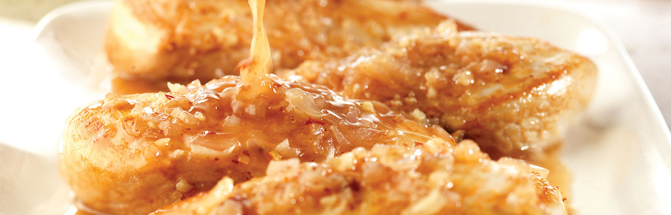 An image of prepared Maple Dijon Chicken made with chicken, shallots, garlic, Swanson® Chicken Broth, Dijon-style mustard and maple-flavored syrup.