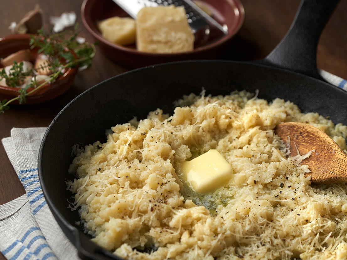 An image of prepared Mashed Parmesan Garlic Cauliflower made with cauliflower, Swanson® Chicken Broth, garlic, Parmesan and butter.