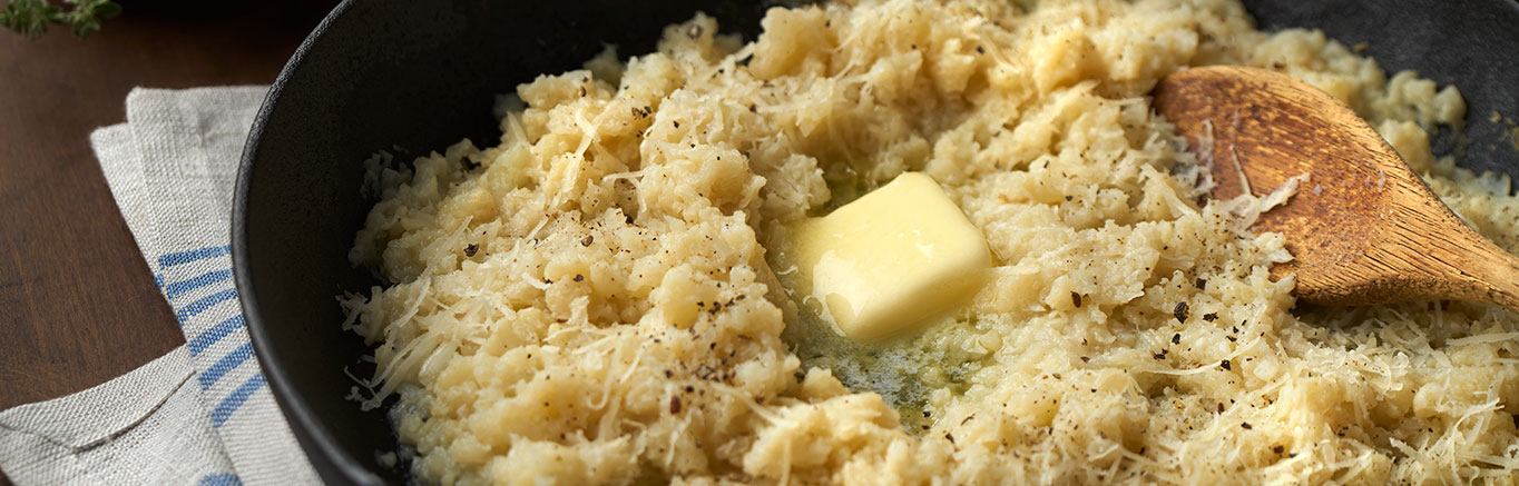 An image of prepared Mashed Parmesan Garlic Cauliflower made with cauliflower, Swanson® Chicken Broth, garlic, Parmesan and butter.