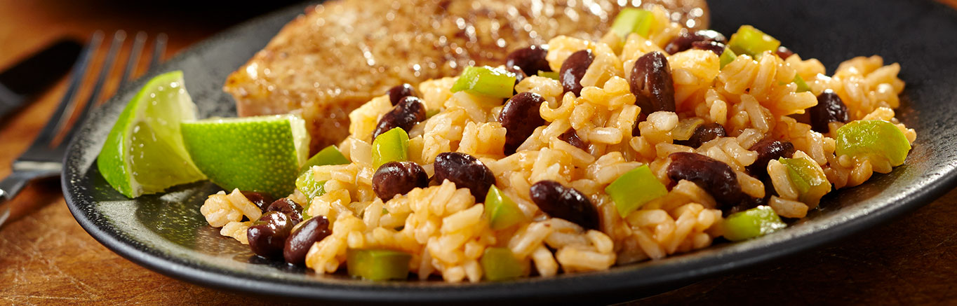 An image of prepared Mexican Beans & Rice made with onion, green pepper, Swanson® Chicken Broth, black beans and cilantro.