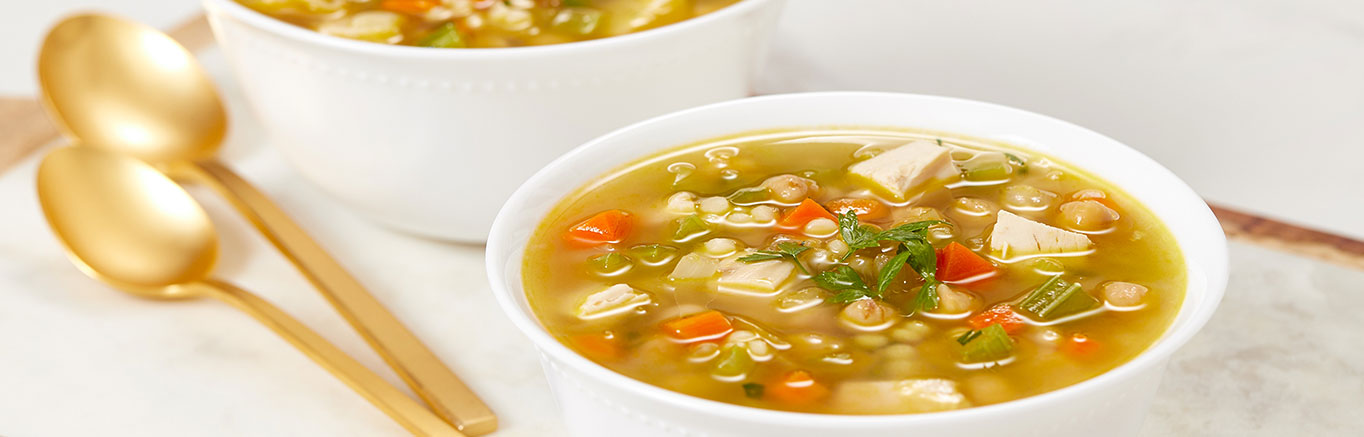 An image of prepared Moroccan Chickpea & Couscous Soup made with Israeli couscous, onion, Swanson® Chicken Broth, chicken and chickpeas.